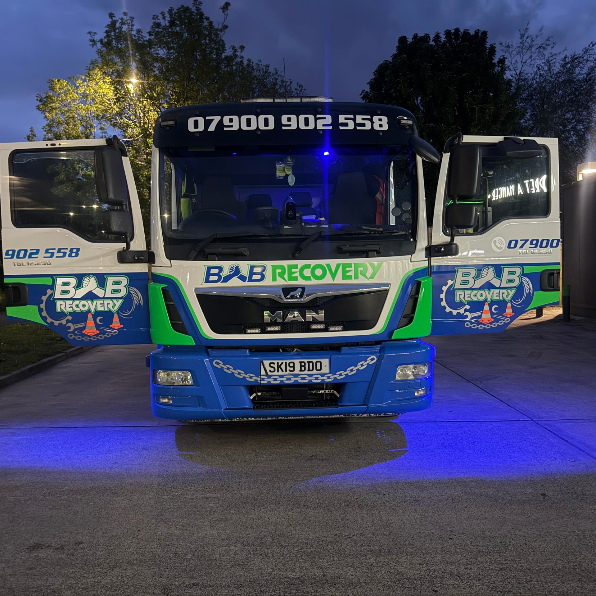 B&B Recovery flatbed truck loaded with a vehicle